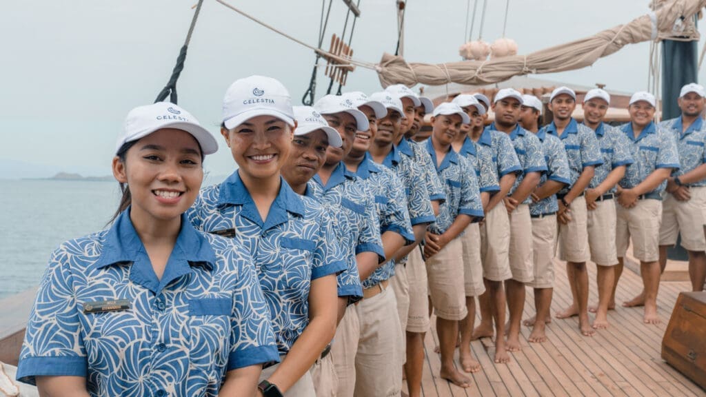 The crew onboard Celestia smiling as they welcome you onboard. 