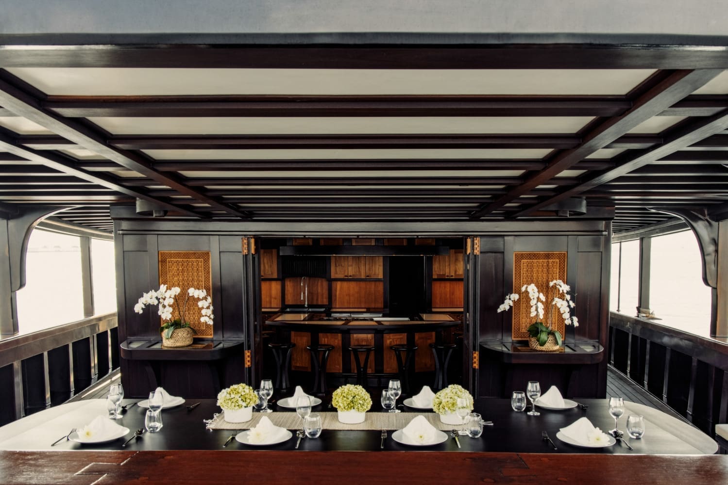The dark brown ironwood construction of Dunia Baru in contrast to the light color decor of the dining area onboard